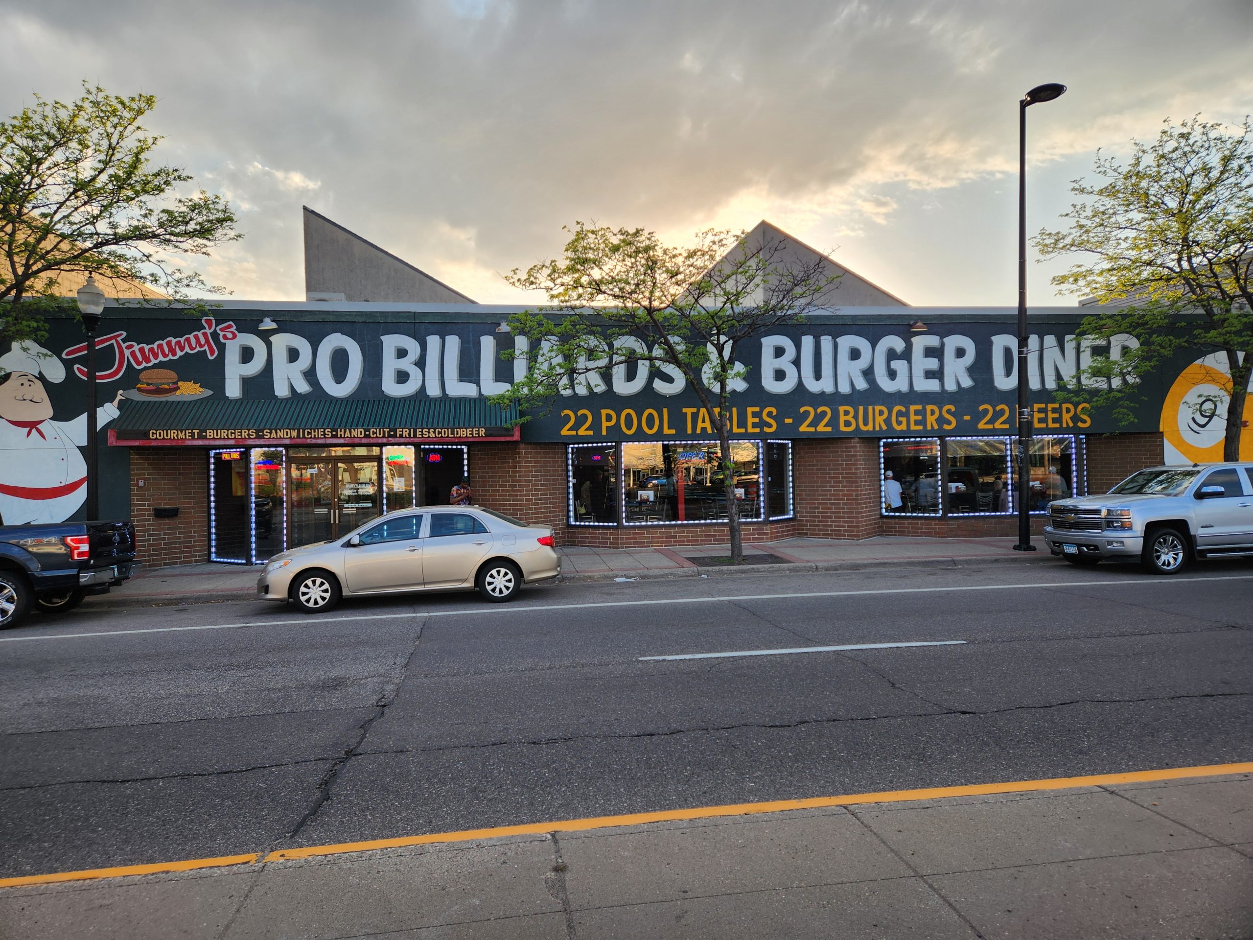 Street view of Jimmy’s Pro Billiards & Burger Diner in the Twin Cities, featuring bold signage, 22 pool tables, 22 burgers, and 22 beers for Minnesota’s billiards community