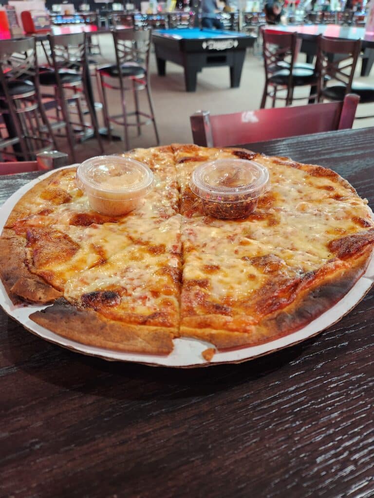 Jimmy's Cheese Pizza with a diamond pool table in the background at Jimmy's bar